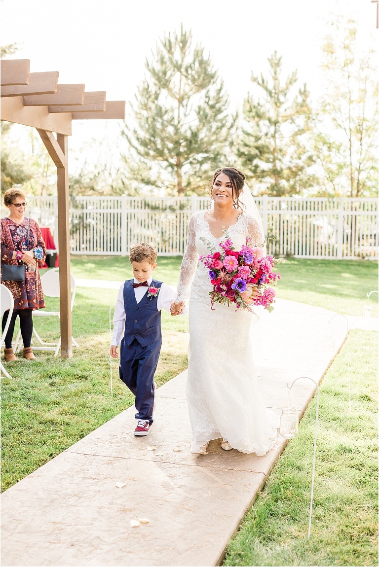 Bride being walked down the aisle by her little son