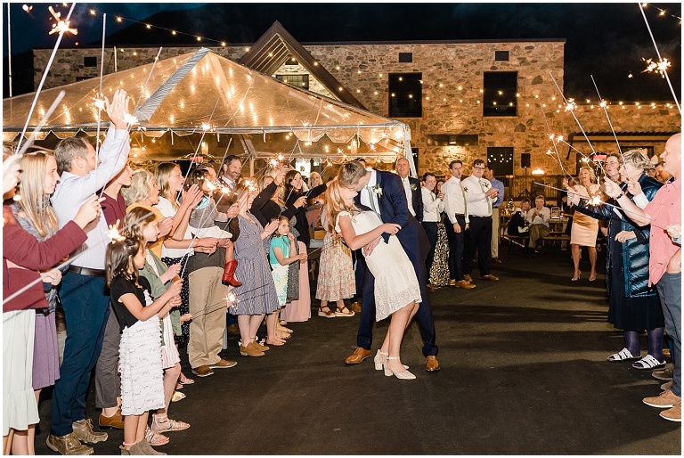 Romantic kiss, sparkler send off at a wedding